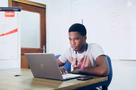 A busy professional in Poland applying for jobs with a laptop